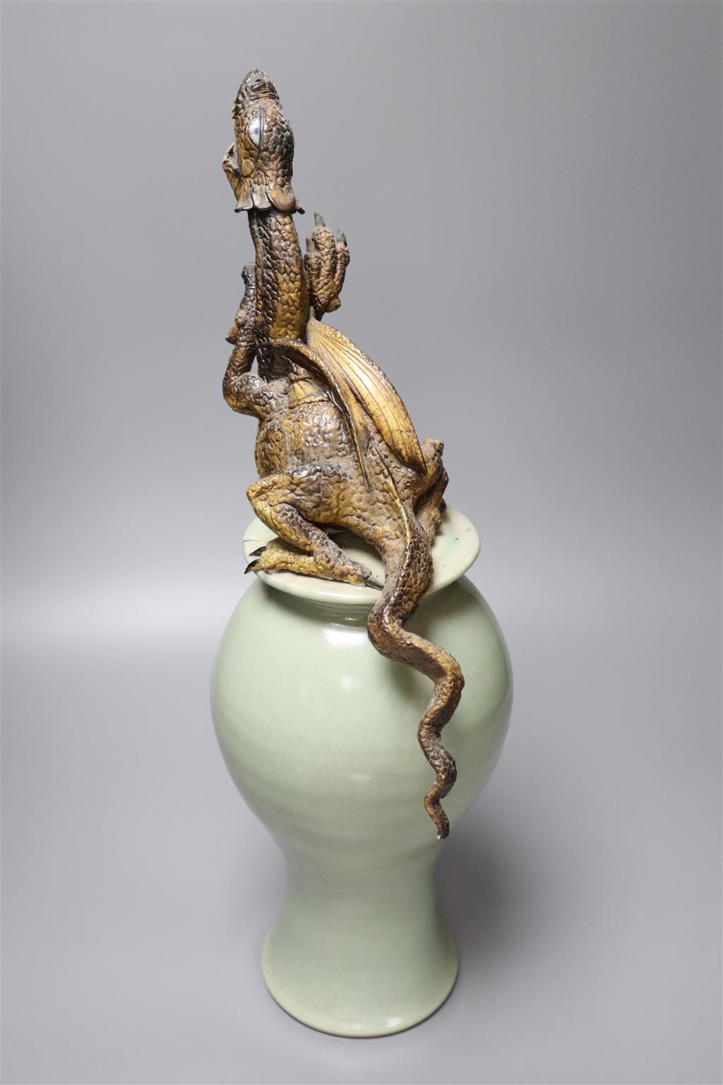 A Chinese celadon vase and cover having later cold-painted metal dragon terminal (repair)